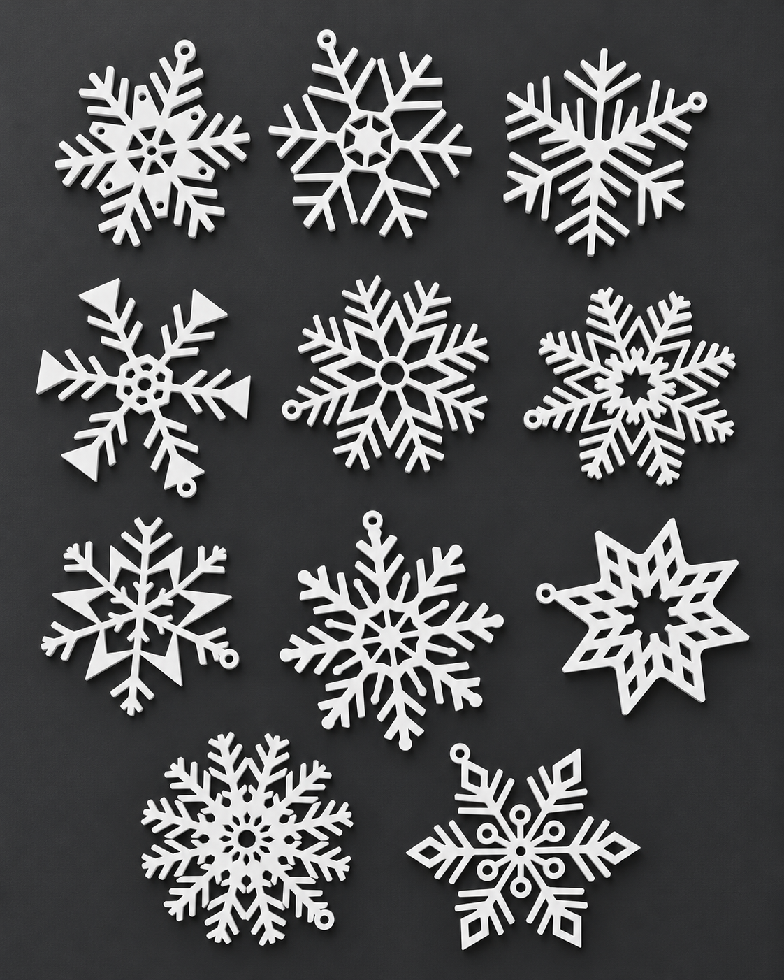 Onze enfeites de floco de neve brancos impressos em 3D sobre fundo grafite.